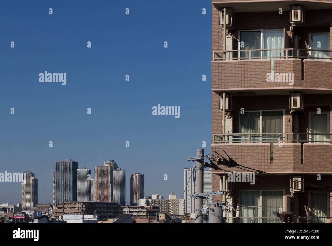 The skyscrapers of Musashi Kosugi seen behind an apartment building in Kashimada, Kawasaki, Kanagawa, Japan. Stock Photo