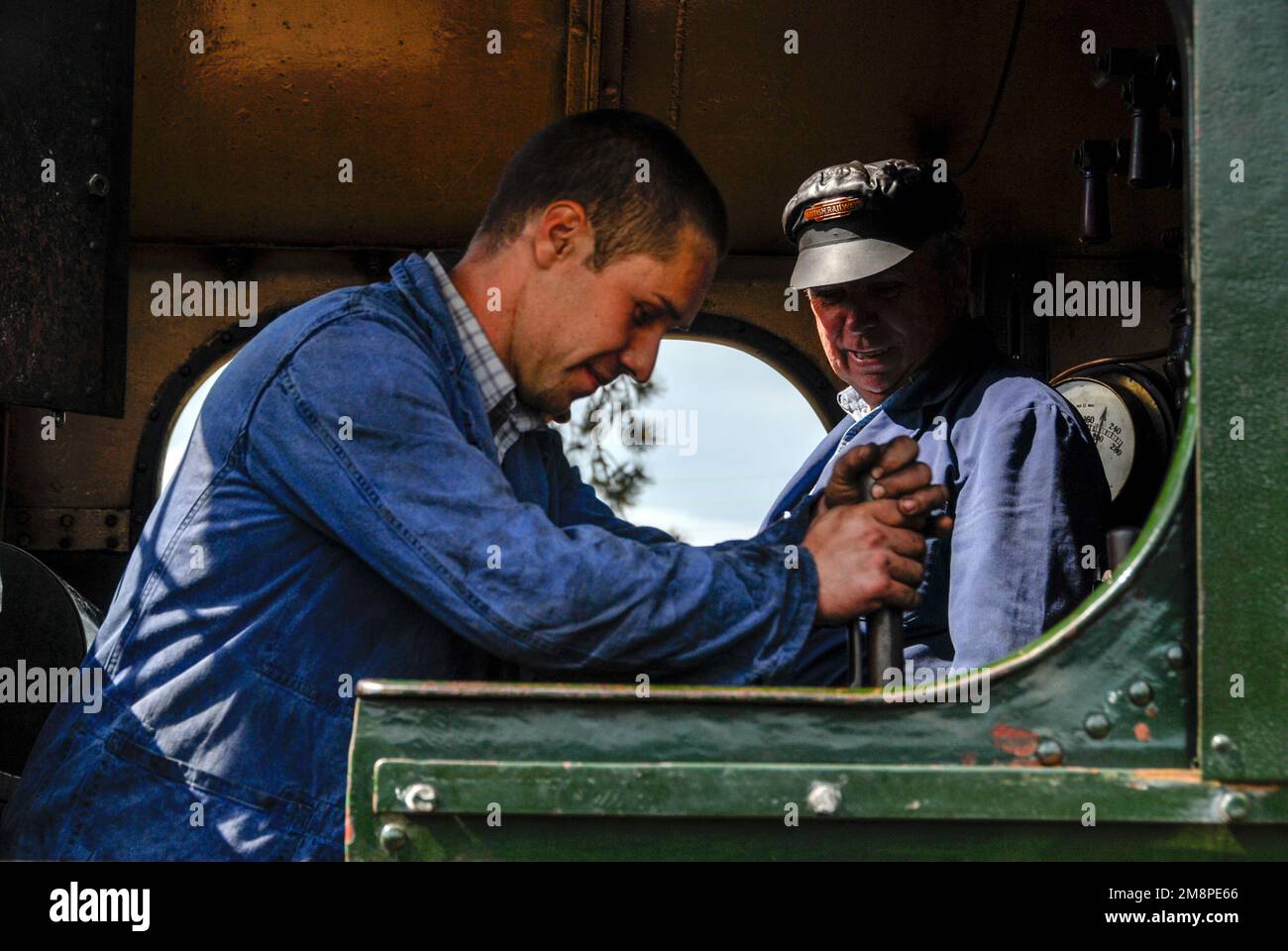 A locomotive driver and fireman on the footplate of a Great Western Railway 4575 Class 5542 locomotive at Winchcombe in the Cotswolds in Britain.  It Stock Photo