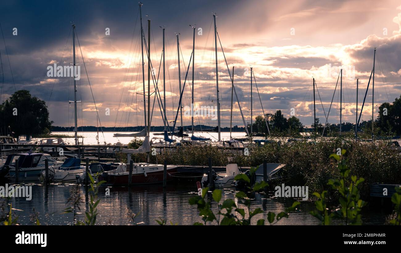 A line of boats moored at the dock during the sunset Stock Photo - Alamy