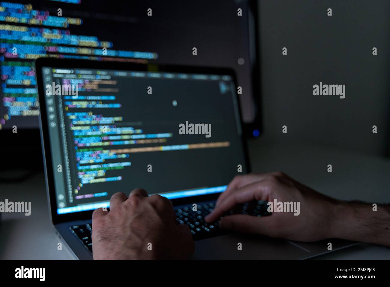 Male hands writing code on laptop. Software and web development with ...