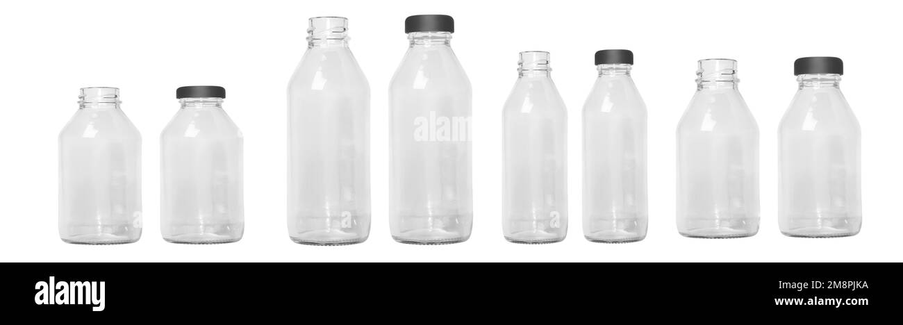 a set of transparent glass bottles of different sizes with a cap, without a cap. Small and large bottles. Empty glass bottles. Stock Photo
