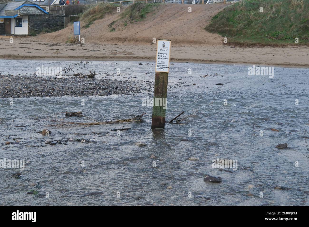 Polzeath, Cornwall, UK. 15th January 2023. Uk Weather. The council run car park next to the beach at Polzeath is starting to be washed away as the small stream that drains into the sea has swollen due to the relentless rainfall. The posts mark the recommended parking area. Credit SImon Maycock / Alamy Live News. Stock Photo