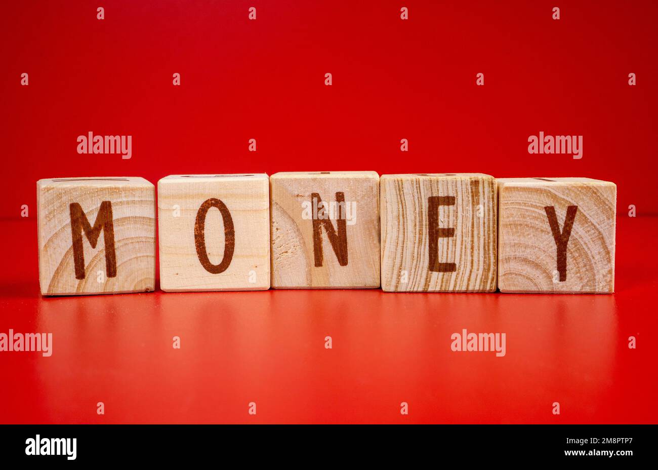 Chinese New Year concept. Money word written on wood block on red ...