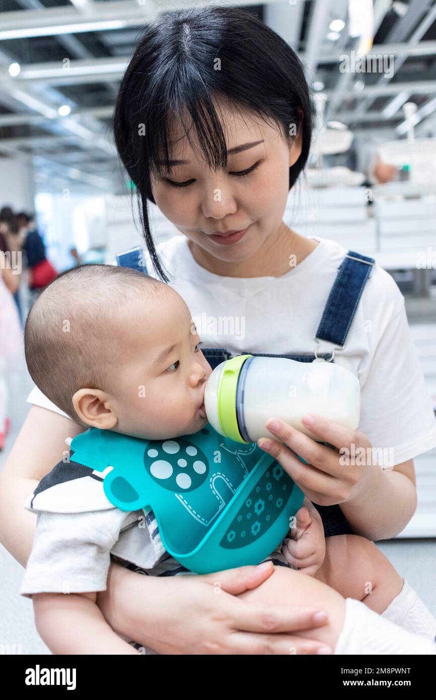 Mother feeding the baby milk Stock Photo