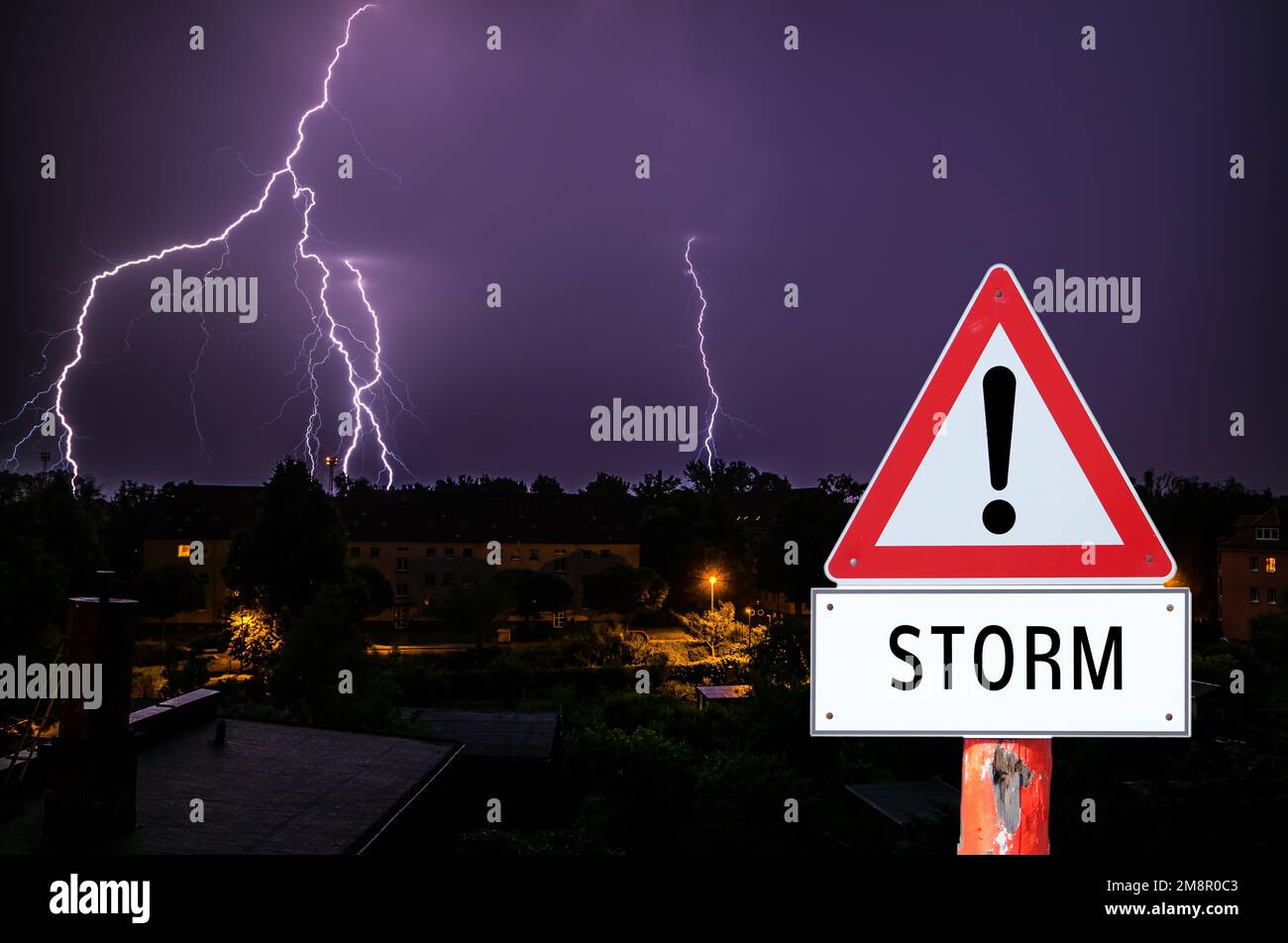 Warning Sign Thunderstorm with lightning over a city Stock Photo