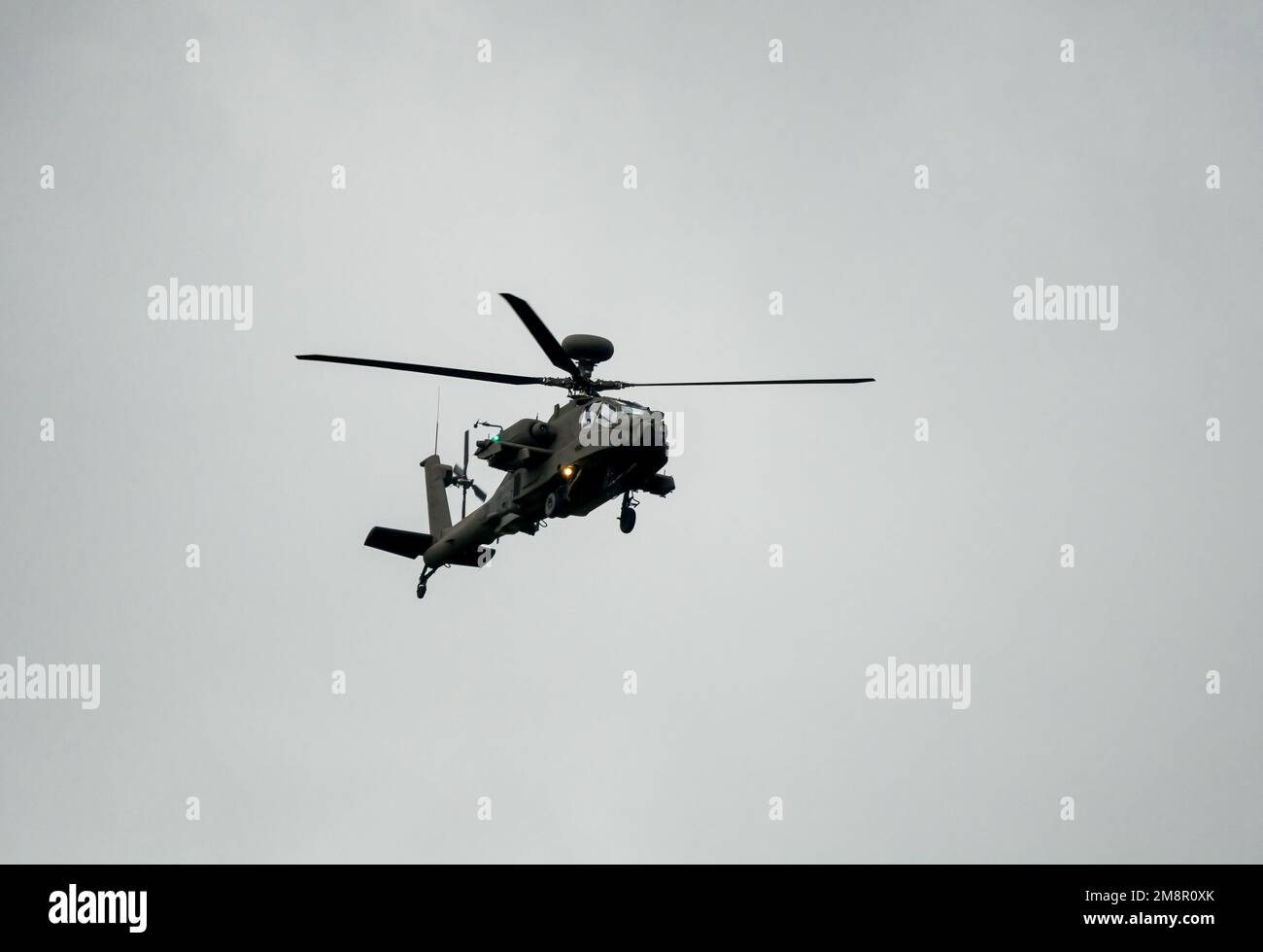close-up of ZM707 British army Boeing Apache Attack helicopter (AH-64E ArmyAir606) in low level flight, Wiltshire UK Stock Photo
