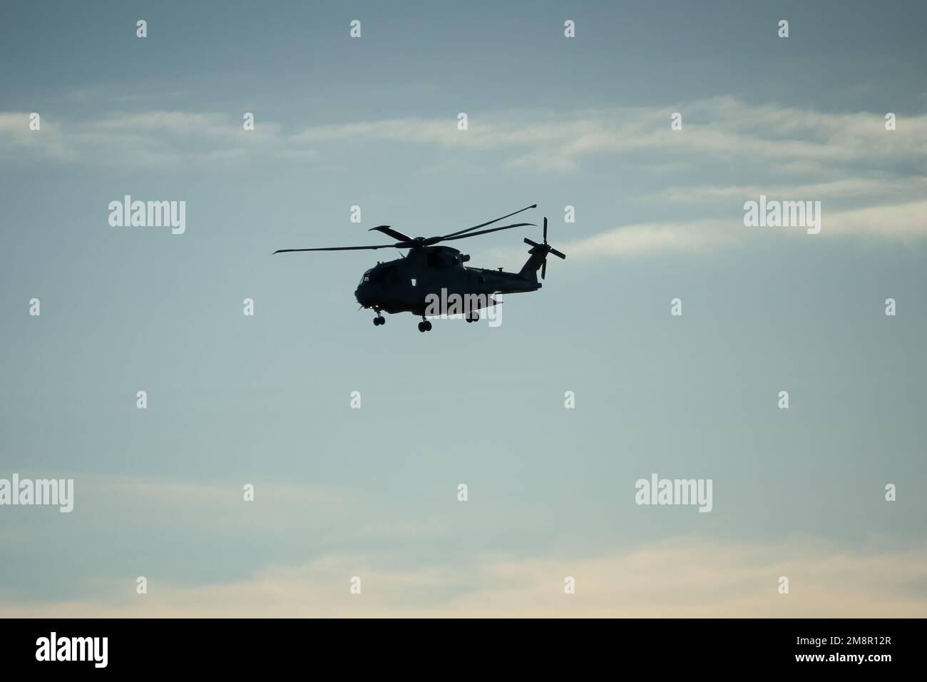 silhouette of British Joint Helicopter Command (JHC) Royal Air Force Puma HC2 on a military exercise, Wiltshire UK Stock Photo