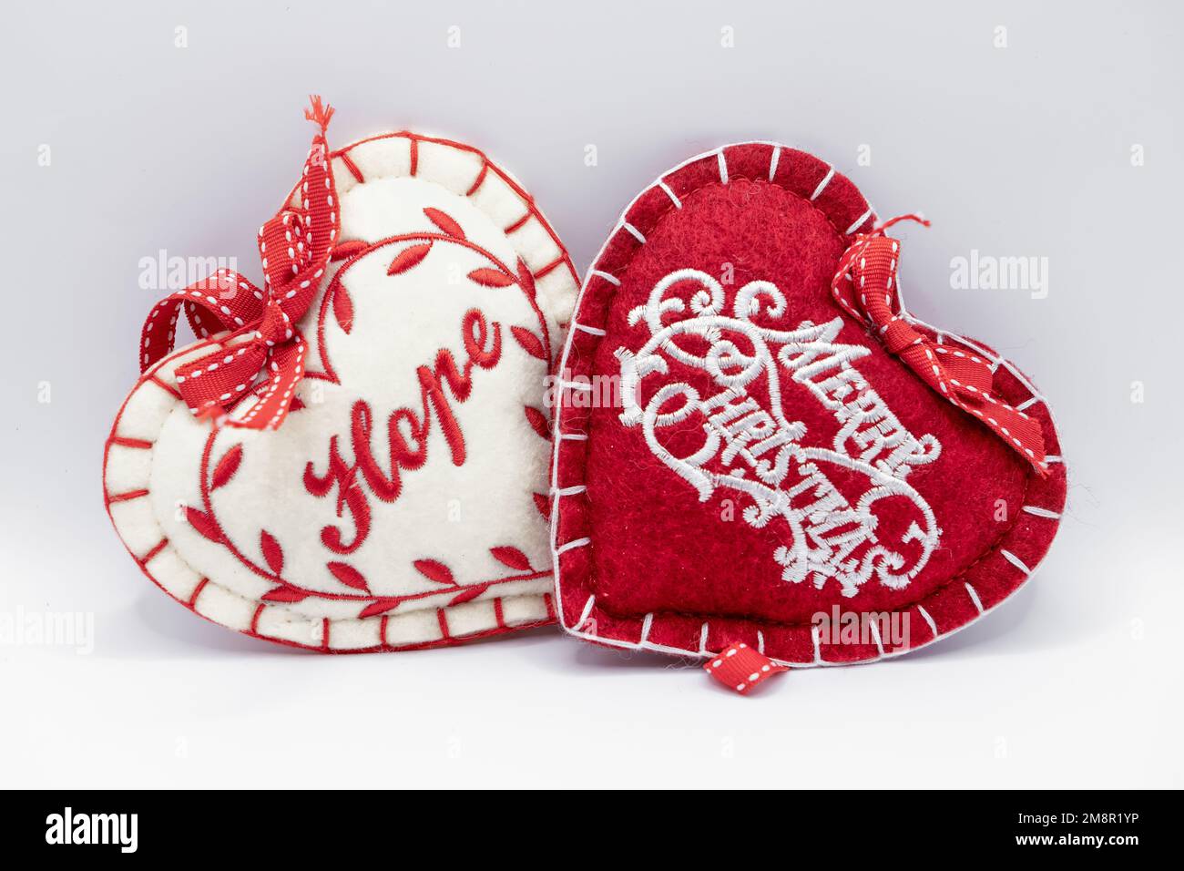red and white heart shaped festive decorations, text of hope and merry christmas Stock Photo
