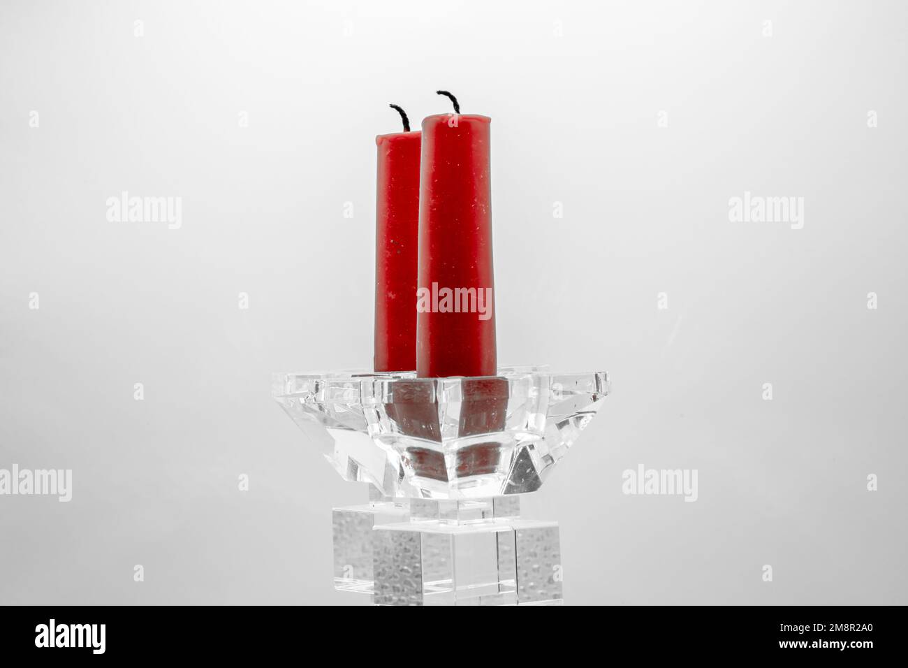 close-up of two red candles in clear glass sculptured candle holders Stock Photo