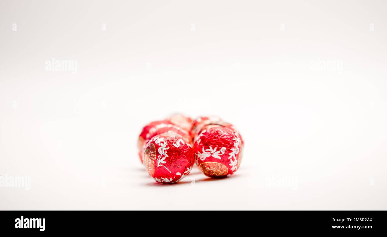 close-up of several red foil wrapped christmas chocolate ball sweets Stock Photo