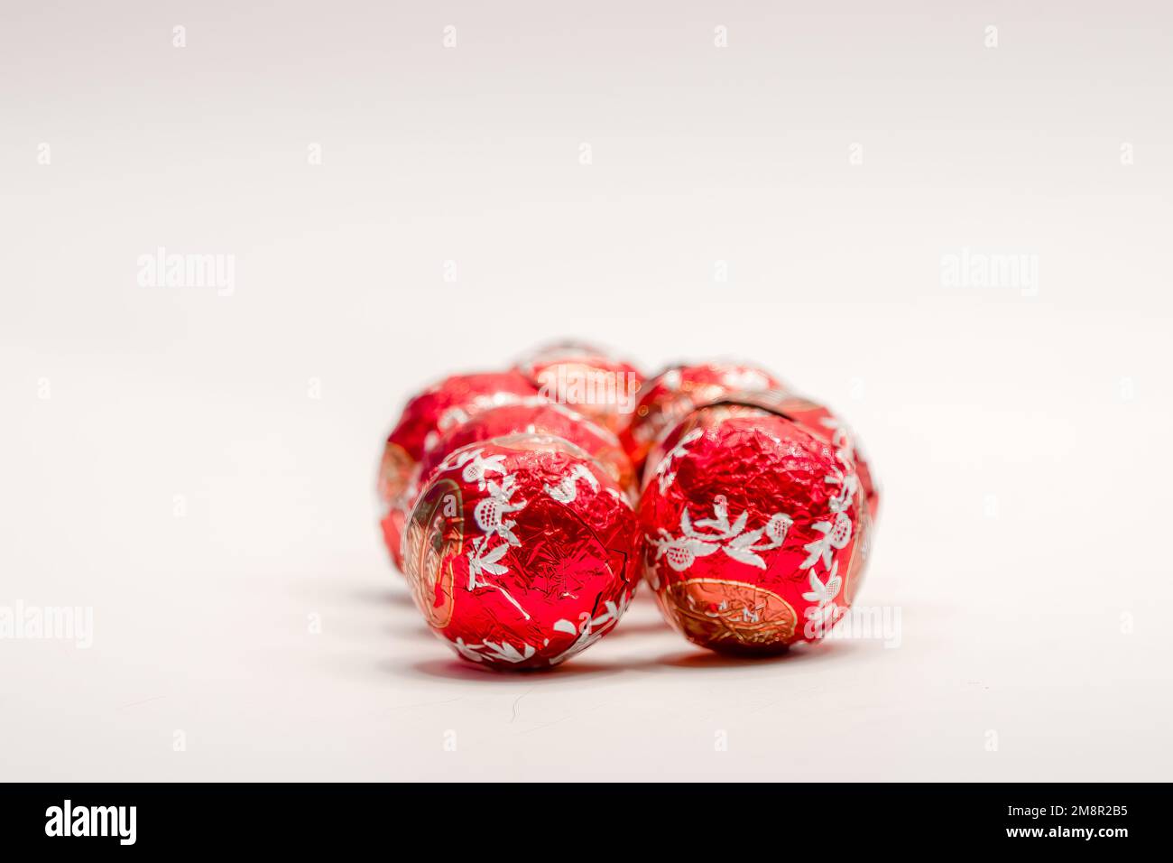 close-up of several red foil wrapped christmas chocolate ball sweets Stock Photo