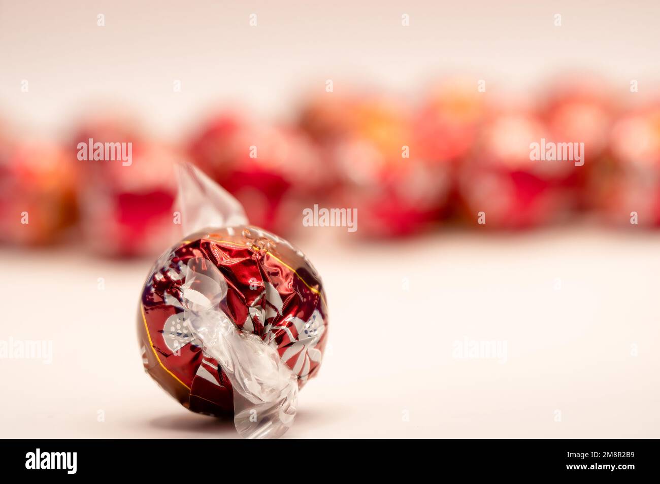 close-up of a red foil wrapped christmas chocolate ball sweet Stock Photo