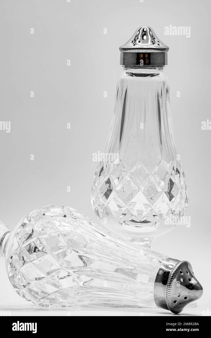 close-up of cut glass crystal salt and pepper shakers with silver tops Stock Photo