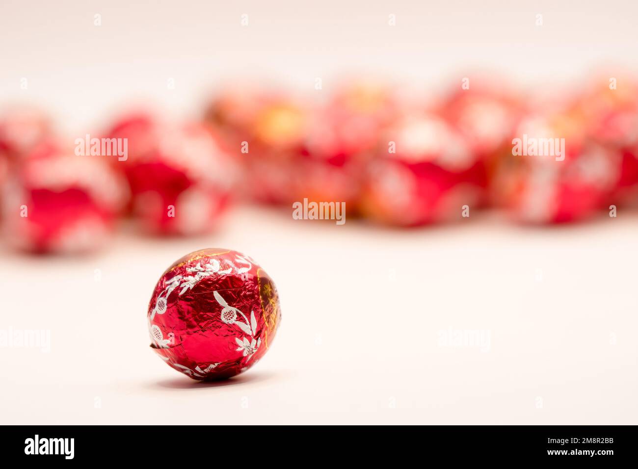 close-up of a red foil wrapped christmas chocolate ball sweet Stock Photo