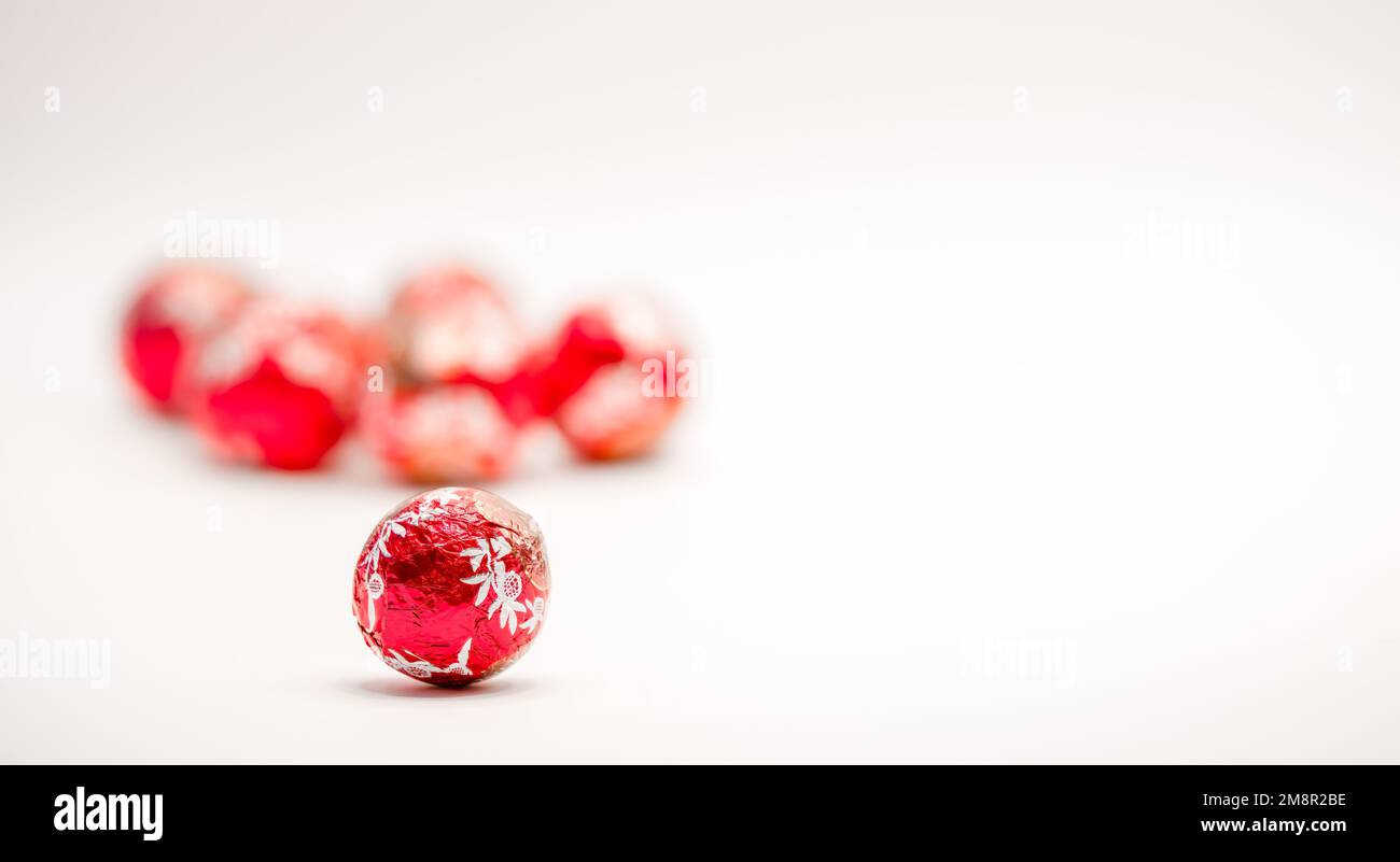 close-up of a red foil wrapped christmas chocolate ball sweet Stock Photo