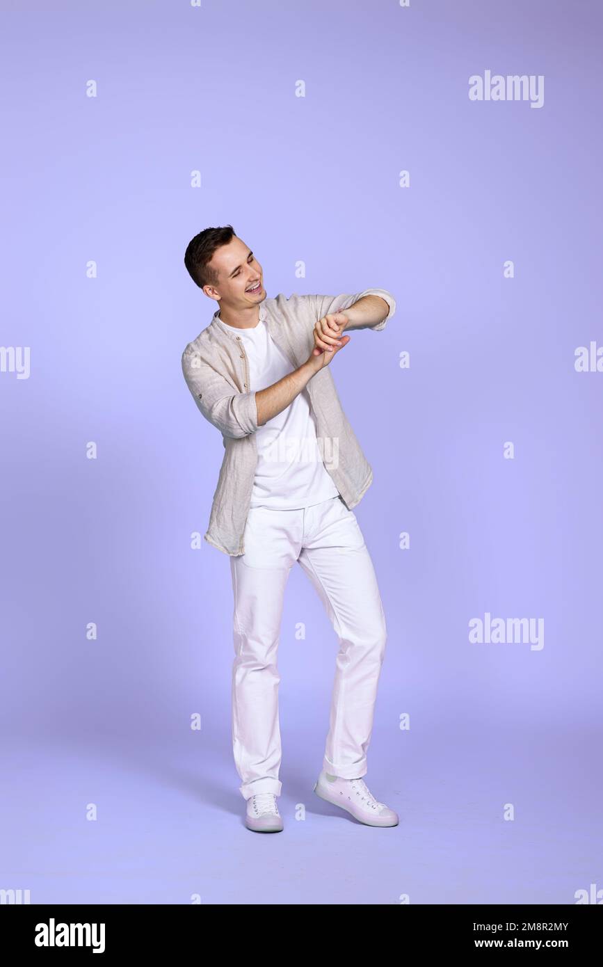 man in casual shirt posing on purple background. Stock Photo