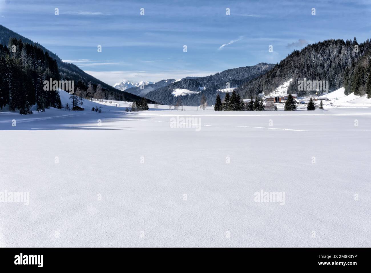 Winter mountain landscape, snow covers the valley, Salzburg Alps, Filzmoos Valley, Europe. Blue sky and white clouds. Stock Photo