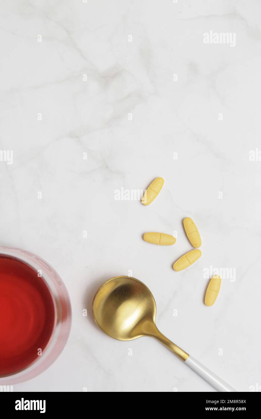 Super food additives. Collagen protein powder, pills, spoon and glass