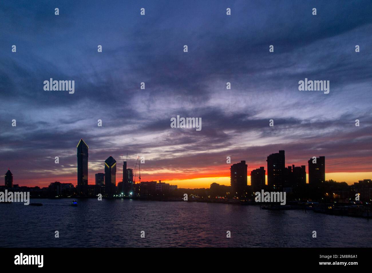The Chelsea Waterfront skyline on the River Thames at sunset with Tower