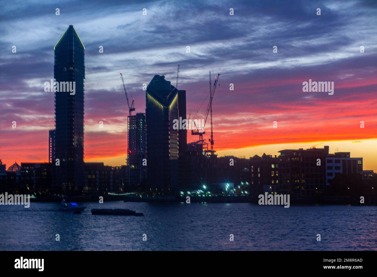 The Chelsea Waterfront skyline on the River Thames at sunset with Tower