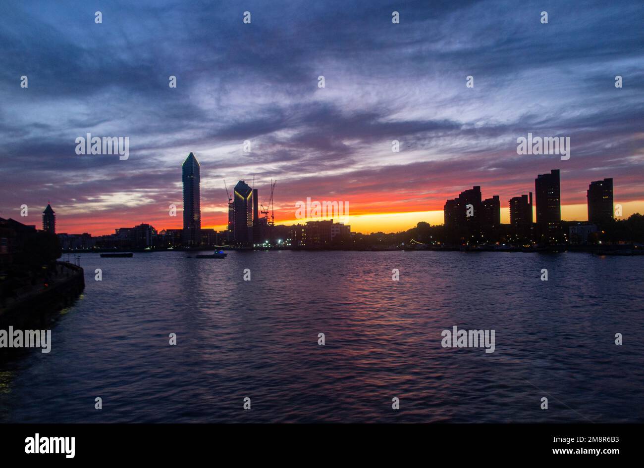 The Chelsea Waterfront skyline on the River Thames at sunset with Tower