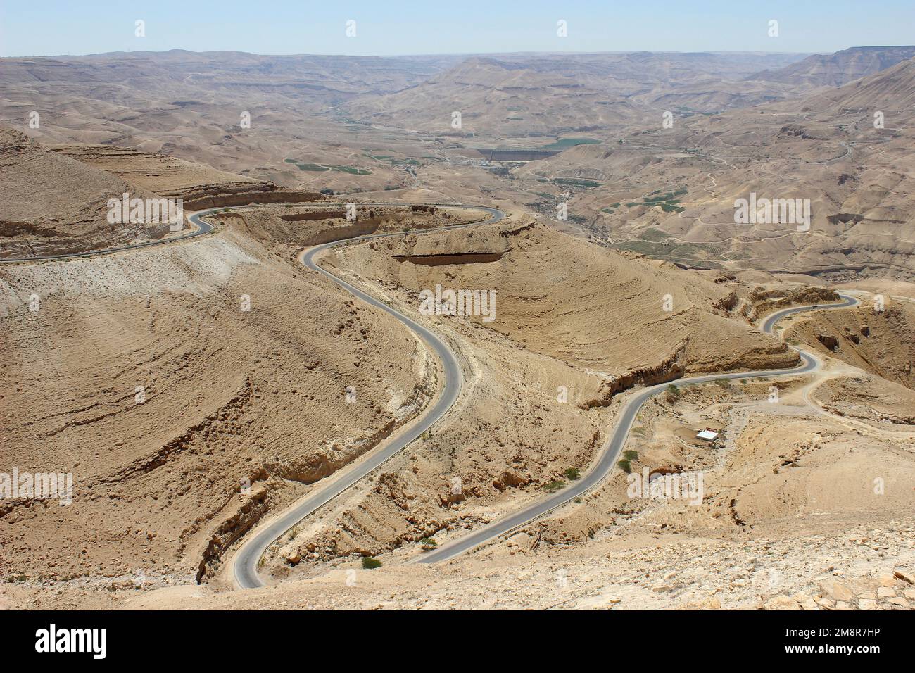 Jordan - winding desert road of the Kings Highway descending into Wadi Mujib Canyon Stock Photo