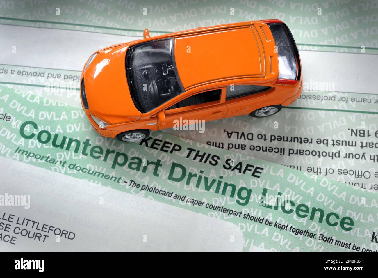 MODEL CAR WITH PAPER COUNTERPART DRIVING LICENCE RE DVLA DRIVERS DRIVING FINES PENALTY POINTS ETC UK Stock Photo