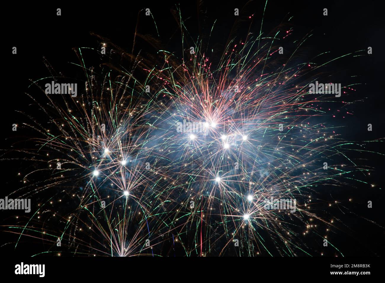 A fireworks display against the night sky Stock Photo