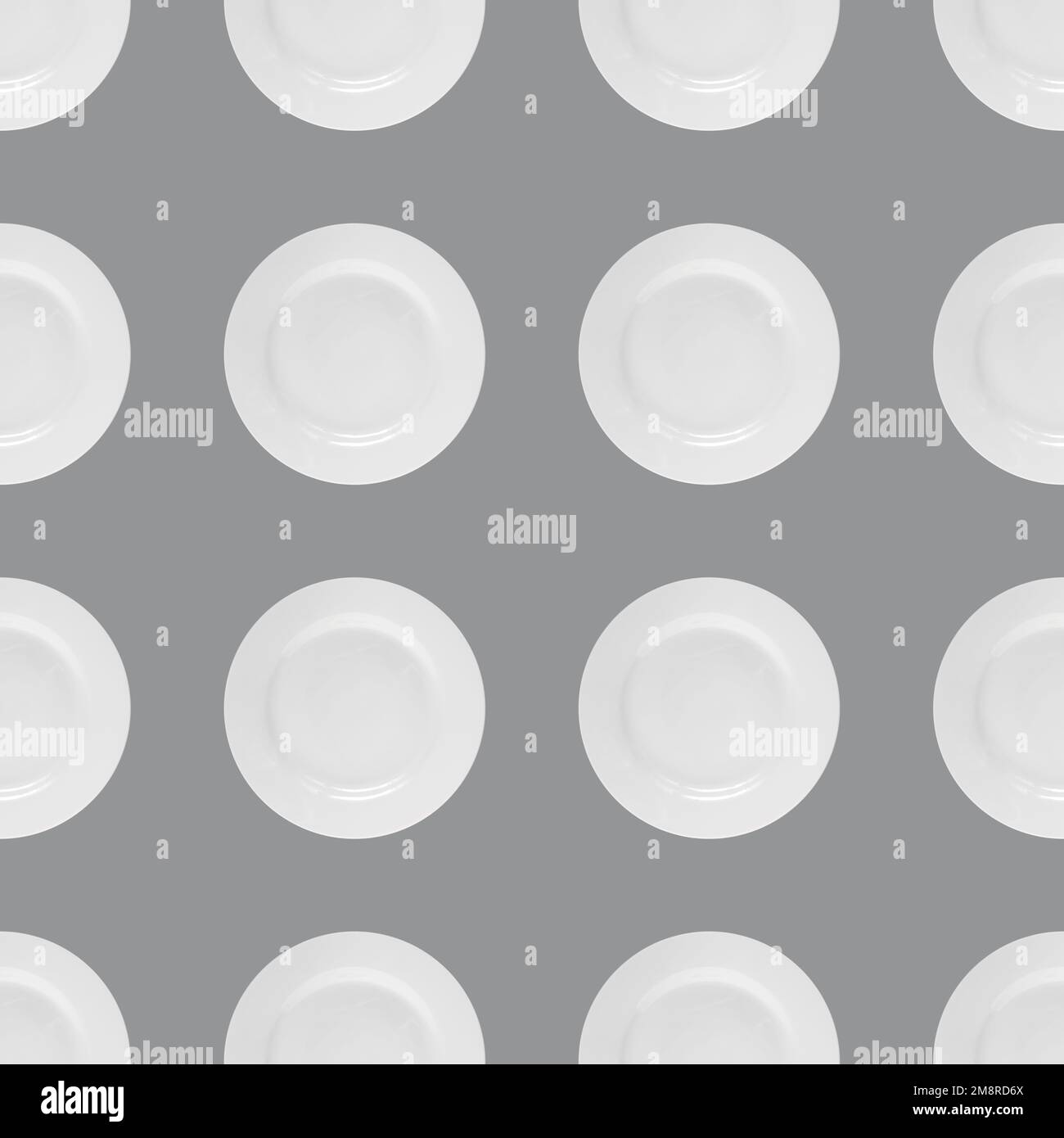 Seamless background with white ceramic plate on gray background Stock Photo