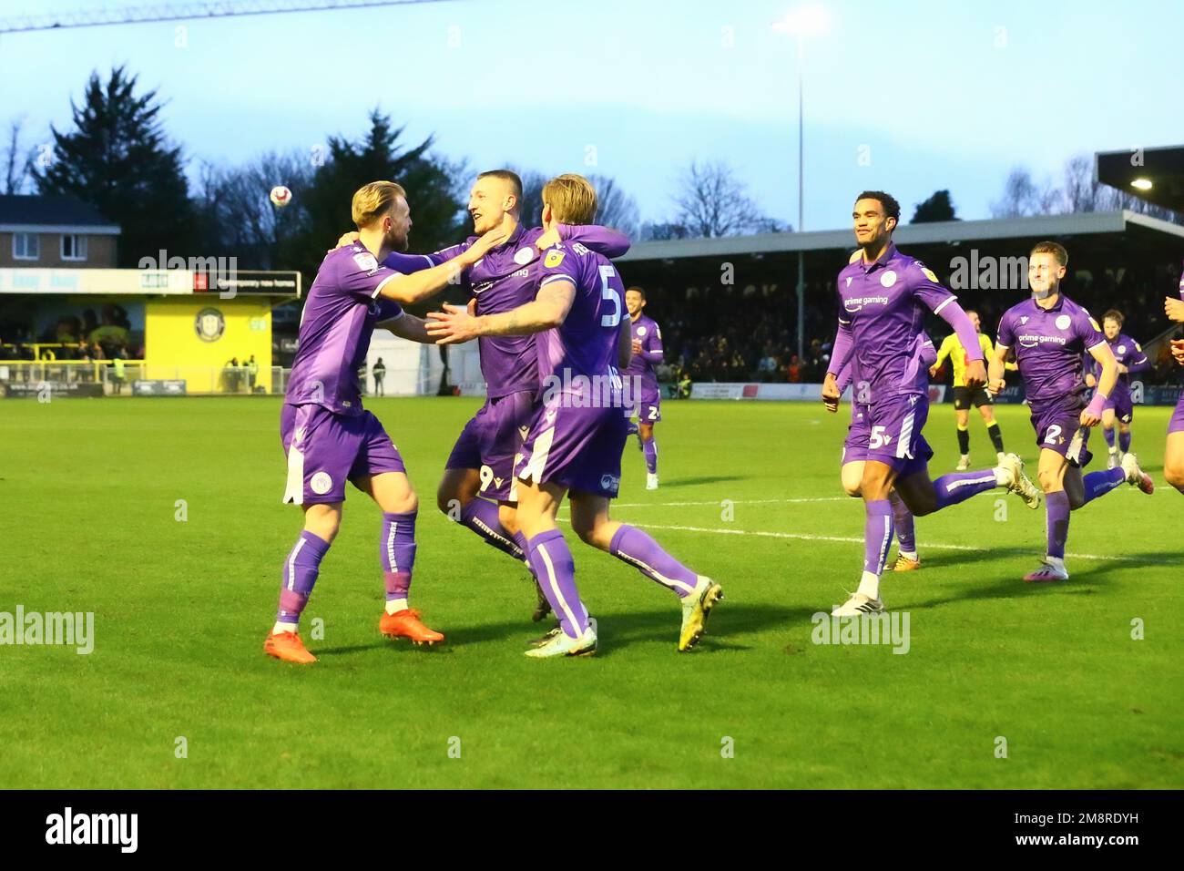 The EnviroVent Stadium, Harrogate, England - 14th January 2023 Carl Piergianni (5) of Stevenage is mobbed by his team mates after he scored the opening goal - during the game Harrogate Town v Stevenage, EFL League 2, 2022/23, at The EnviroVent Stadium, Harrogate, England - 14th January 2023  Credit: Arthur Haigh/WhiteRosePhotos/Alamy Live News Stock Photo