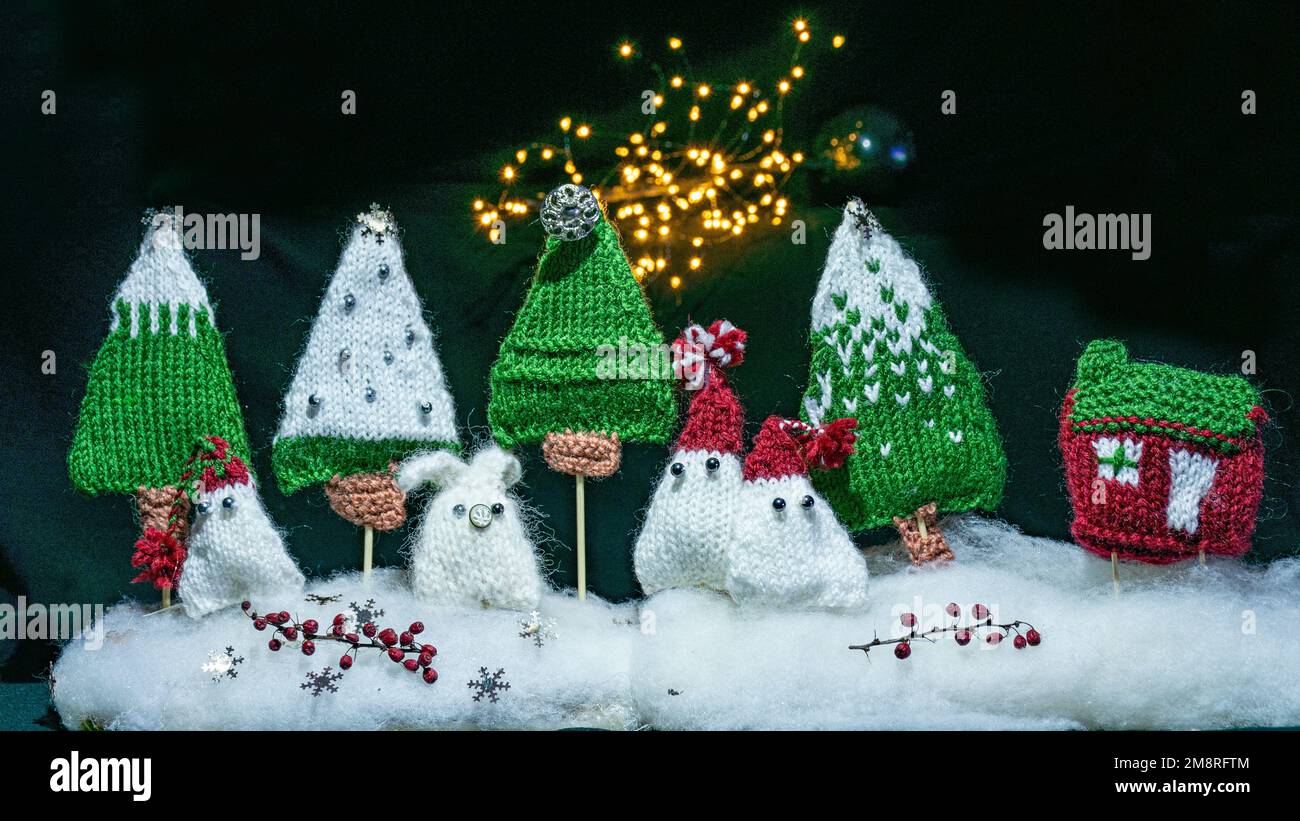 knitted trees, houses and gnomes, fairy tale characters, night view, color light painting photo, blurred background, craft concept, winter fairy tale Stock Photo