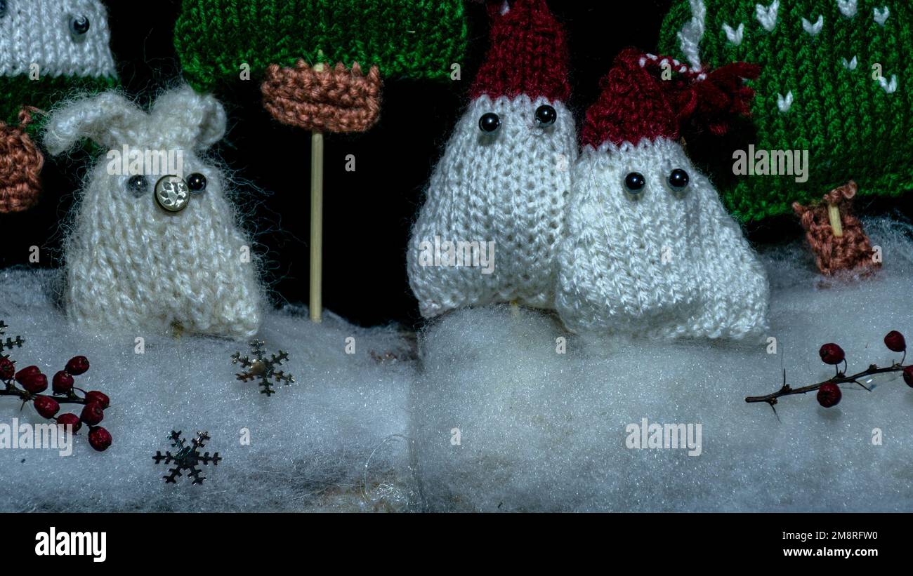 knitted gnomes, fairy tale characters, night view, color light painting photo, blurred background, craft concept, winter fairy tale Stock Photo