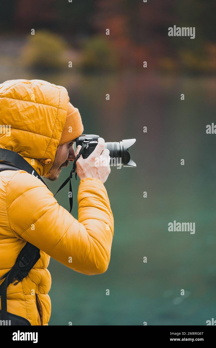 Selective focus of photographer taking landscape photos using digital camera Stock Photo