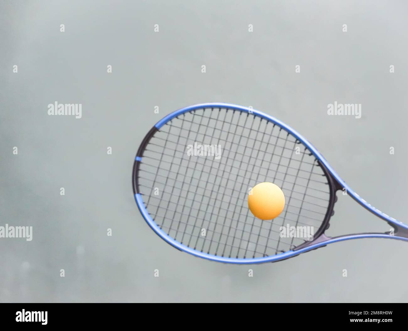 a tennis racket hits the ball in the air on the wall Stock Photo - Alamy
