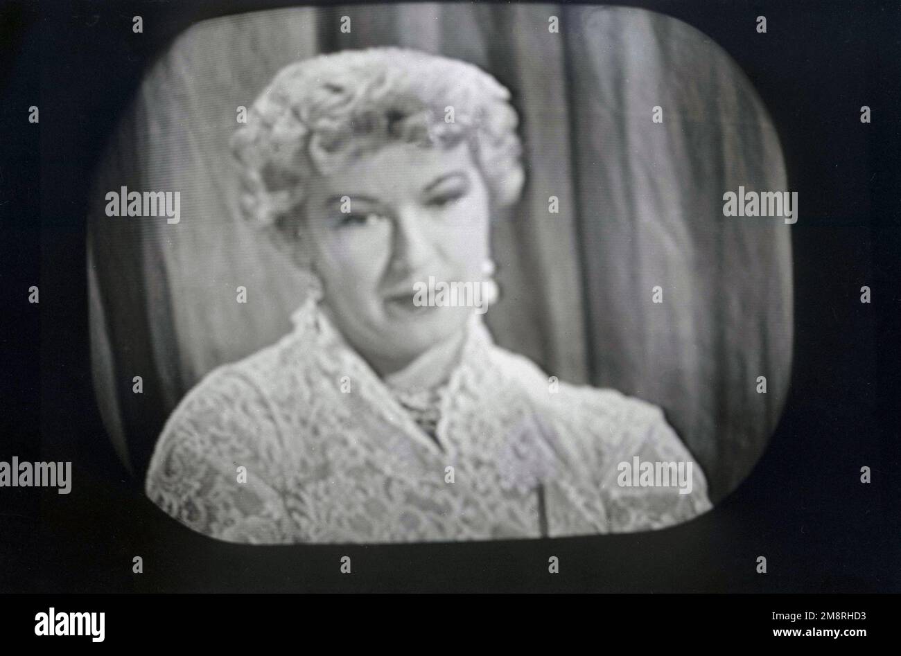1957, historical, the actress Barbara Kelly on BBC Television appearing in the British game show, What's My Line?. Broadcast on BBC television from 1951 to 1963, the panel game show was based on the US version of the same name, and was one of most popular television programmes of the era. The show's panelists had to question contestants to try and guess their occupation, i.e their 'line of work'. Born in Vancover, Canada, Barbara Kelly was one of the regualr panelists on the original BBC series. Stock Photo