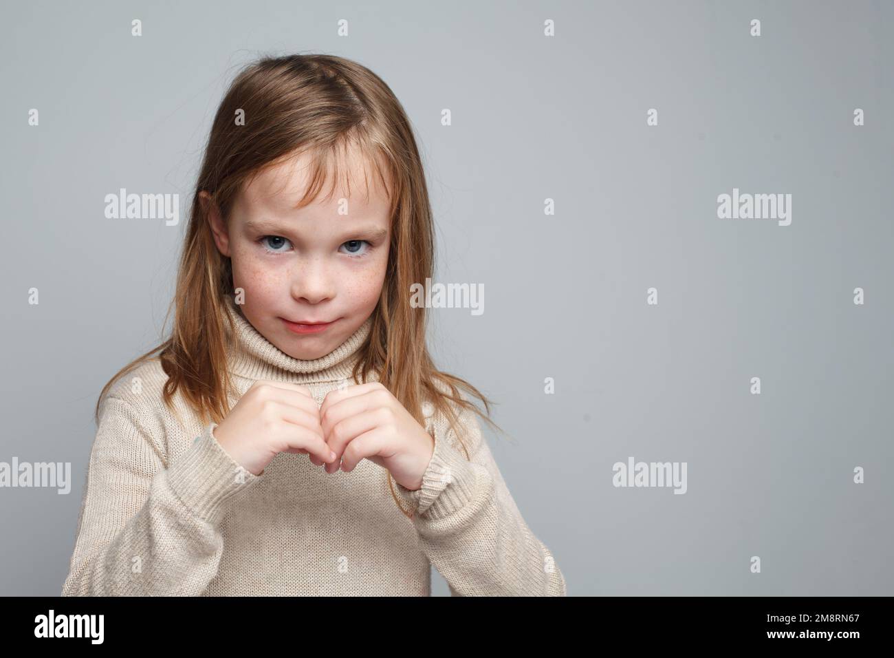 Cheerful smiling little girl looking at camera on gray background Stock ...