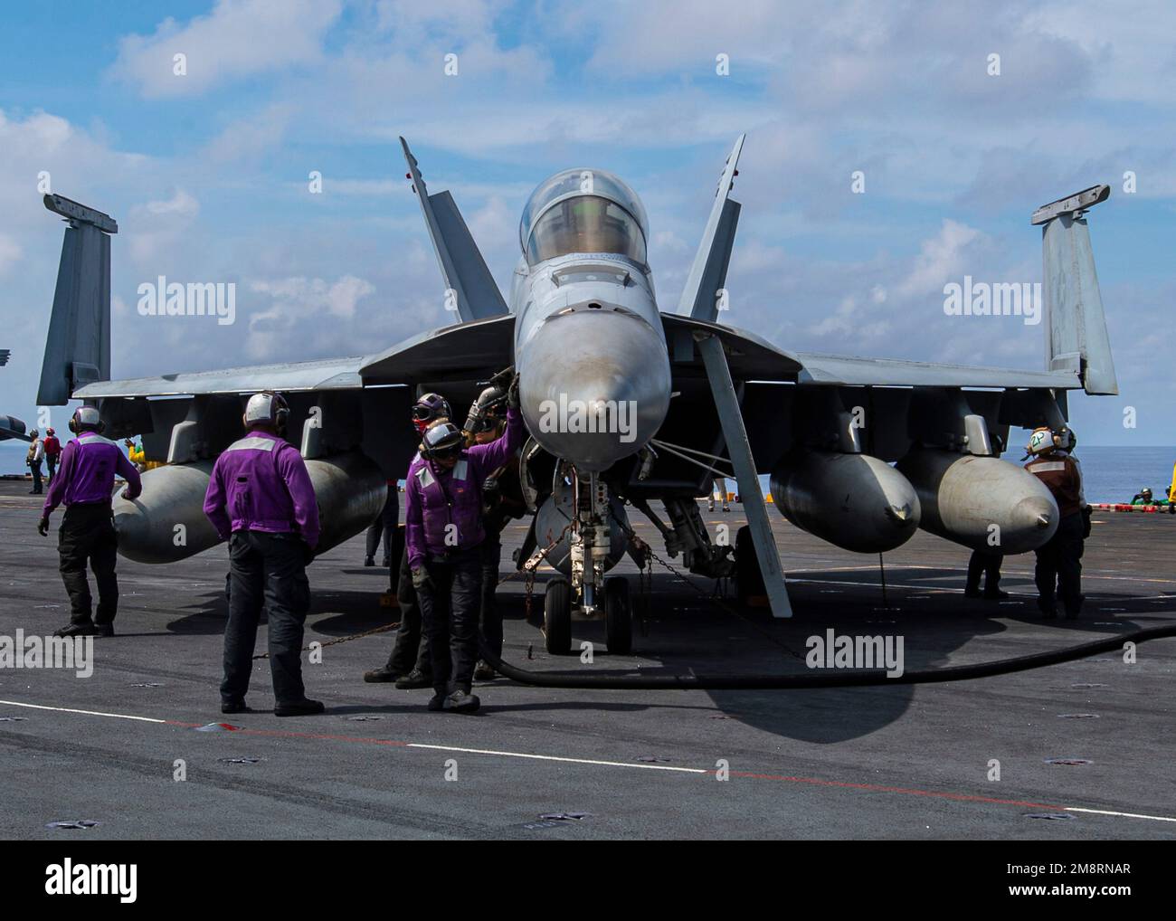 South China Sea, International Waters. 14th Jan, 2023. South China Sea, International Waters. 14 January, 2023. A U.S. Navy flight deck safety officer directs a F/A-18F Super Hornet fighter aircraft, with the Fighting Redcocks of Strike Fighter Squadron 22 to launch from the flight deck of the Nimitz-class aircraft carrier USS Nimitz, January 14, 2023 operating in the South China Sea. Credit: MC3 Joseph Calabrese/U.S. Navy/Alamy Live News Stock Photo