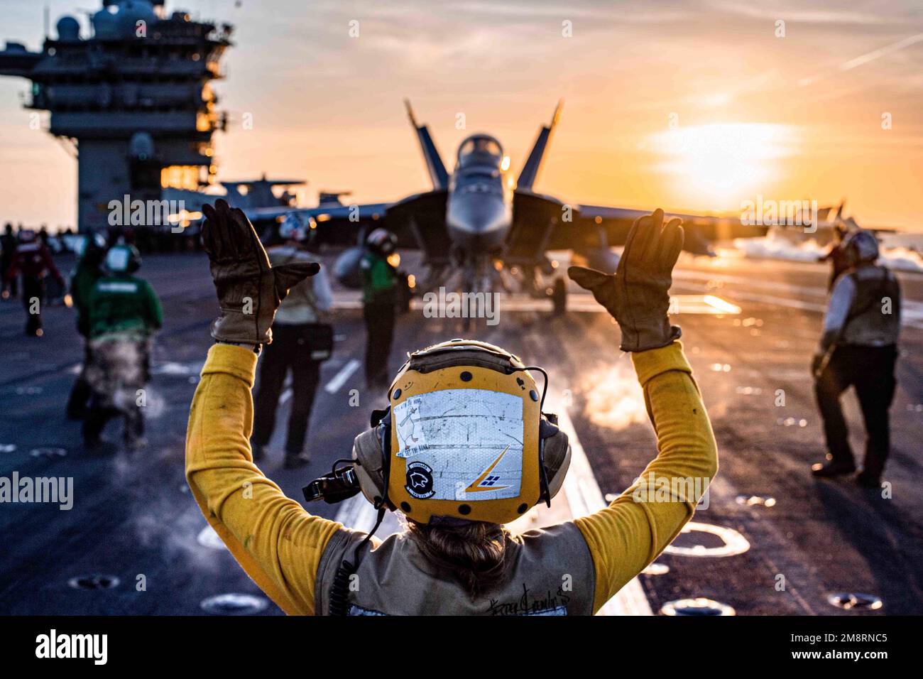USS Nimitz, United States. 13th Jan, 2023. A U.S. Navy F/A-18E Super Hornet fighter aircraft from the Mighty Shrikes of Strike Fighter Squadron 94, is positioned for launch on the flight deck of the Nimitz-class aircraft carrier USS Nimitz at sunset underway conducting routine operations, January 13, 2023 in the South China Sea. Credit: MC2 David Rowe/U.S Navy Photo/Alamy Live News Stock Photo
