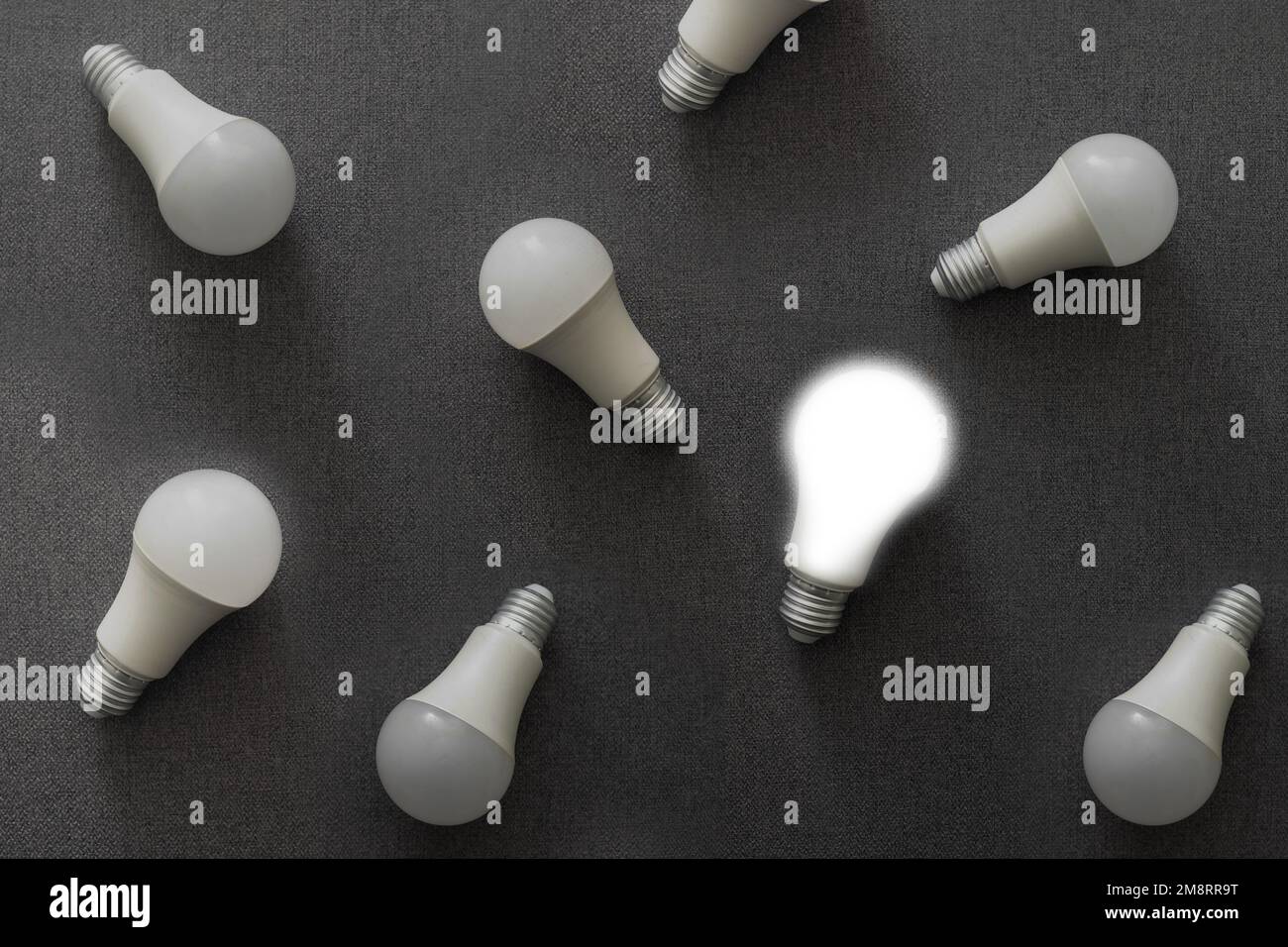 LED light bulbs on gray color background. Flat lay. Pattern. Stock Photo