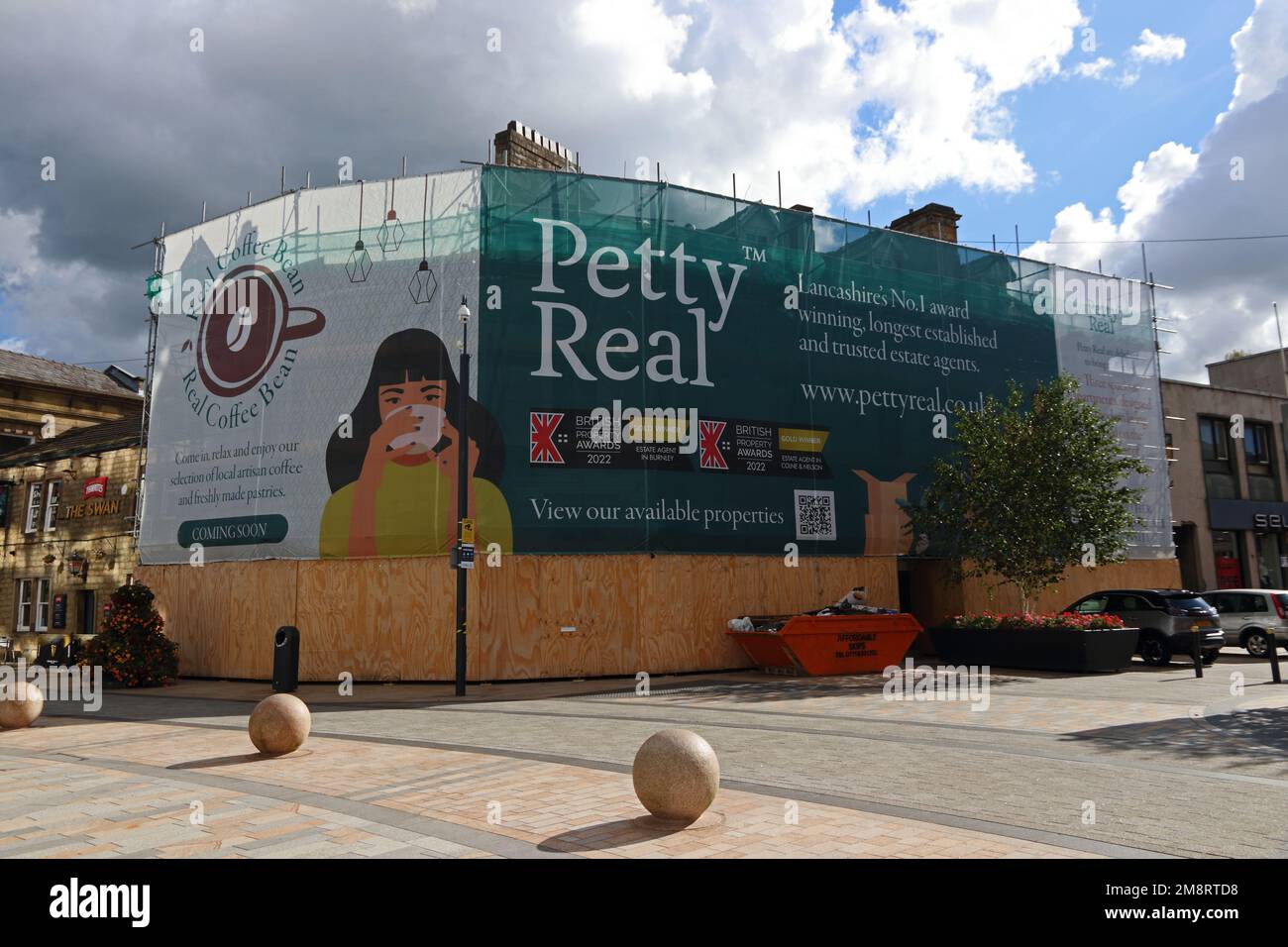 Building redevelopment covered by large advertising hoarding, Burnley Stock Photo