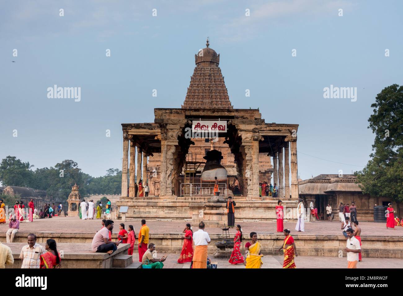 Brihadisvara temple full view with nandi mandapam with pilgrims walking around Stock Photo