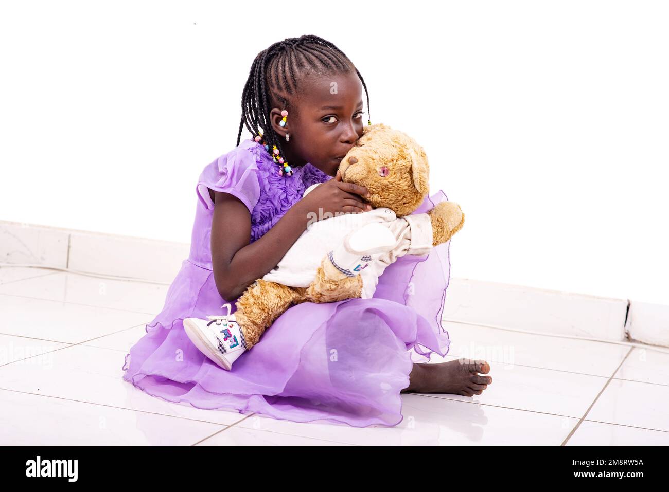 Little girl hugging teddy bear on sale