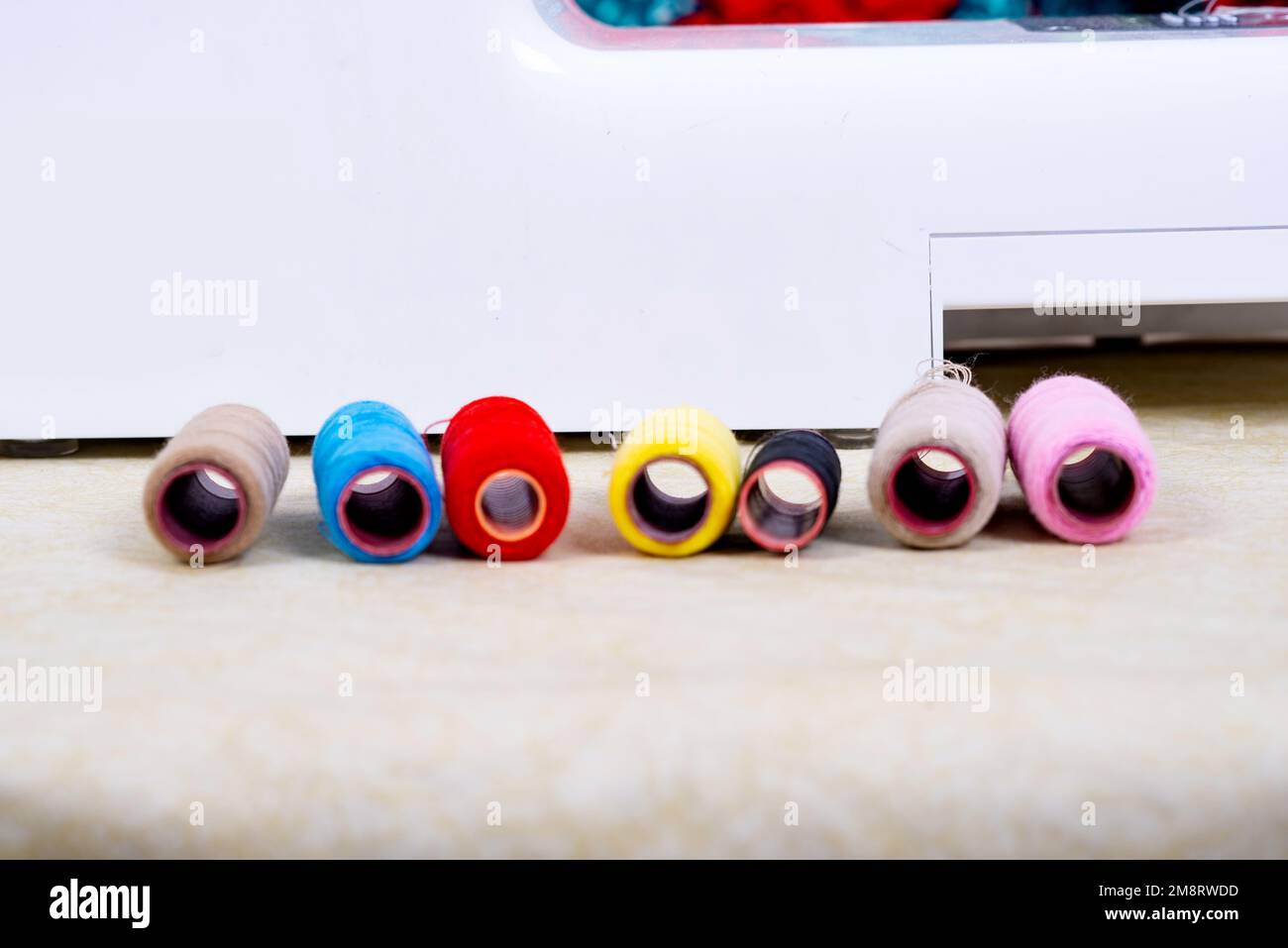 set of colored sewing threads for sewing on a machine. Stock Photo