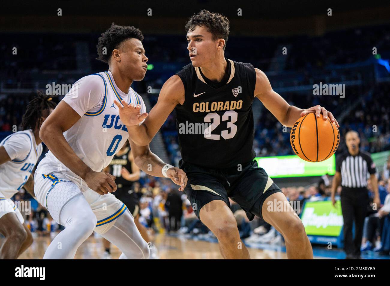 Colorado Buffaloes forward Tristan da Silva (23) is guarded by UCLA