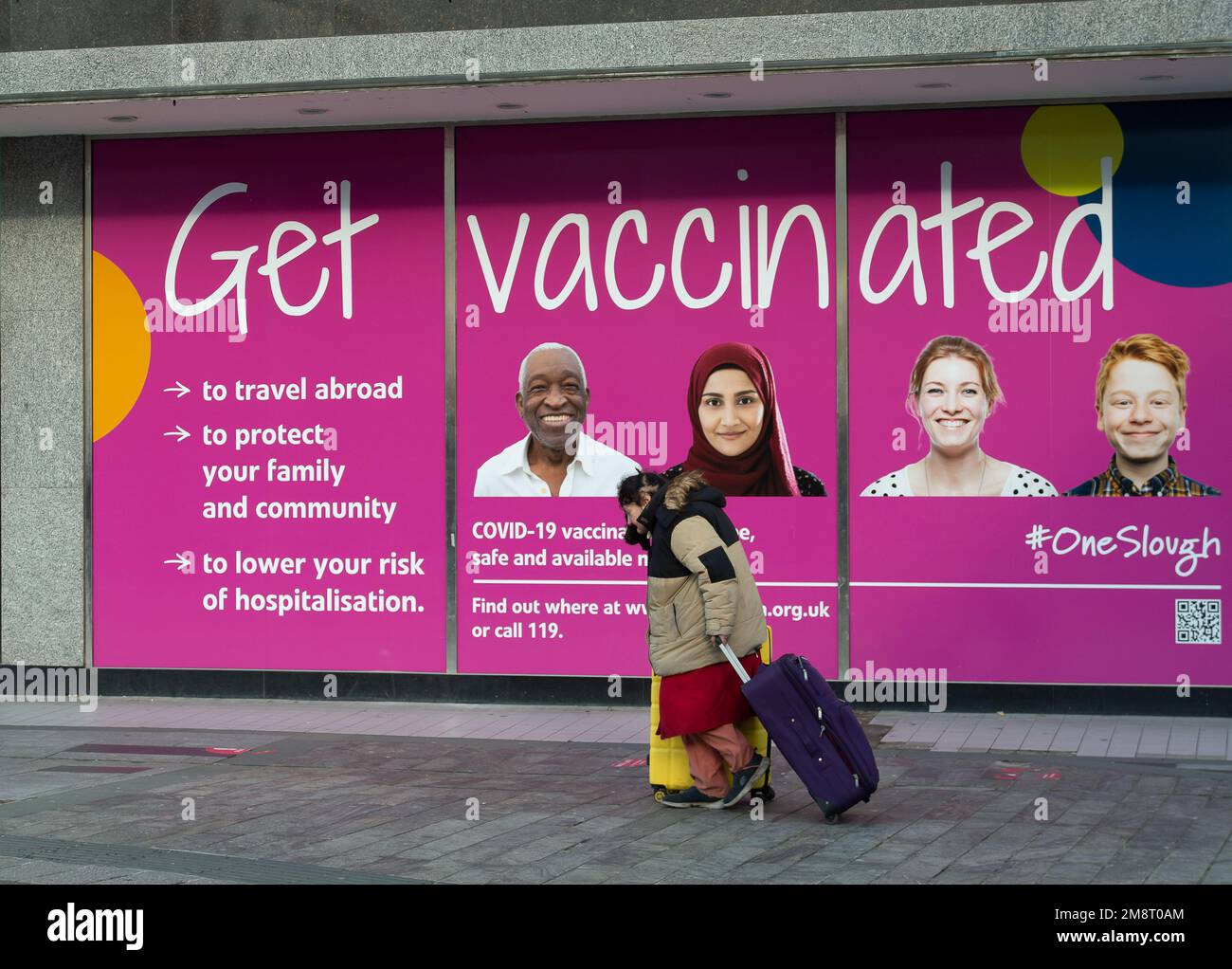 Slough, Berkshire, UK. 15th January, 2023. A homeless lady walks past a Get Vaccinated sign in Slough High Street. A new Covid-19 XBB.1.5 variant known as Kraken is now showing up in tests in the UK. People are still being advised to get their Covid-19 booster vaccines. The number of people with positive Covid-19 tests over the Christmas period spiked again. Credit: Maureen McLean/Alamy Live News Stock Photo