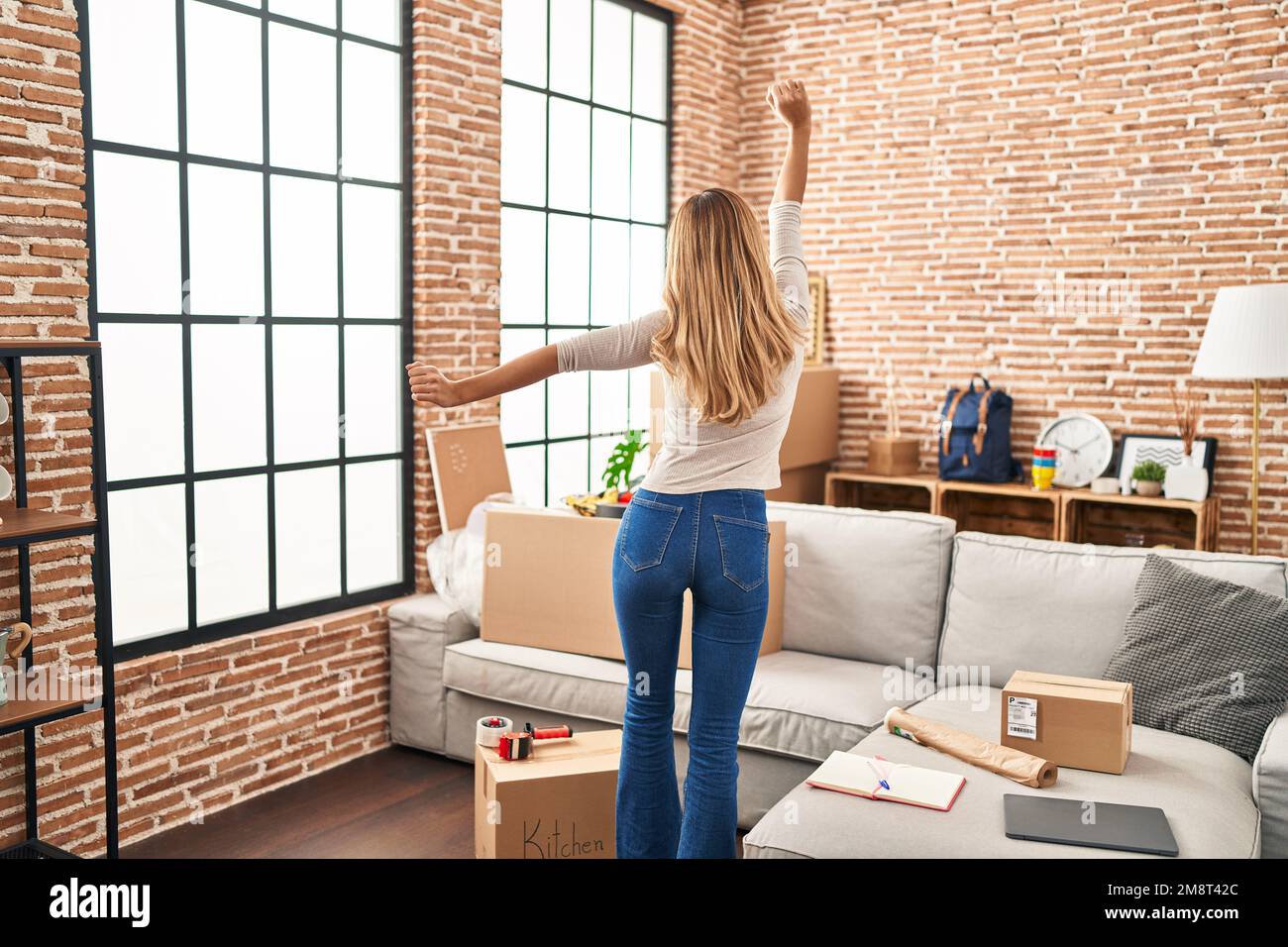 Blonde woman dancing back view hi-res stock photography and images - Alamy