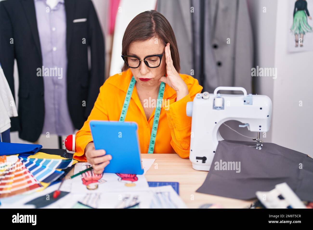 Senior female tailor using hi-res stock photography and images - Alamy
