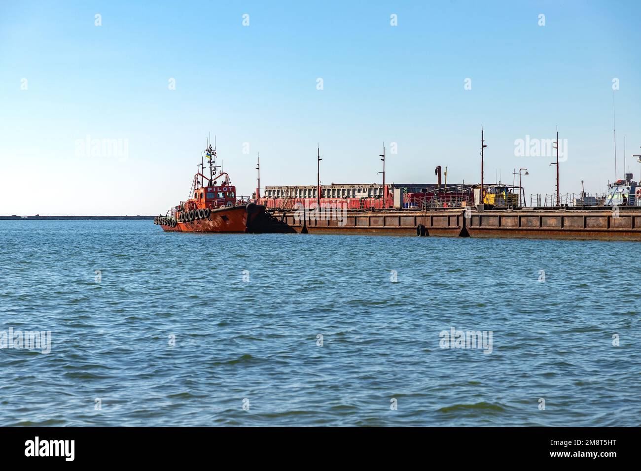 Boats and ships in cargo port of Berdyansk, Ukraine. Ukrainian cargo port on Azov sea. Stock Photo
