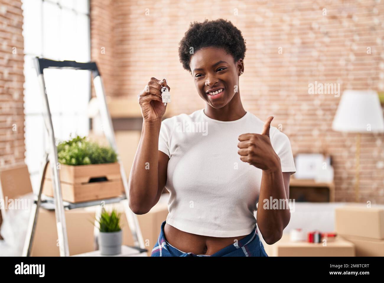 African american woman holding keys of new home smiling happy and ...