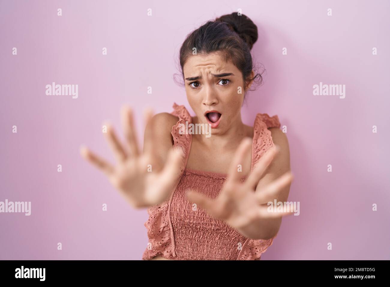 Young Teenager Girl Standing Over Pink Background Afraid And Terrified With Fear Expression Stop 0362